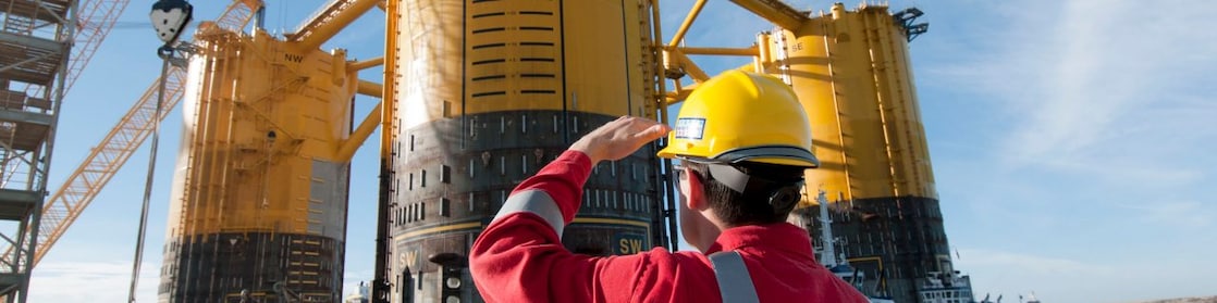 Engineer looking up at platform under construction