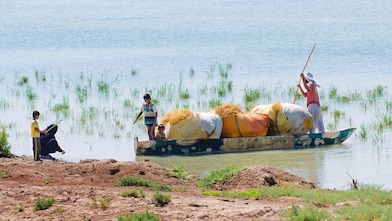 Local people cross the flooded Hawizeh Marshes, near the Majnoon project in Iraq