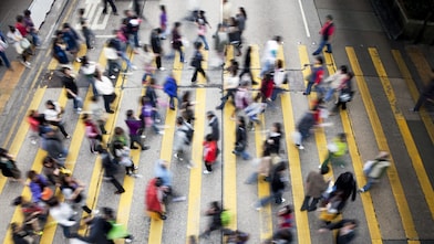 People crossing a busy street in hong kong