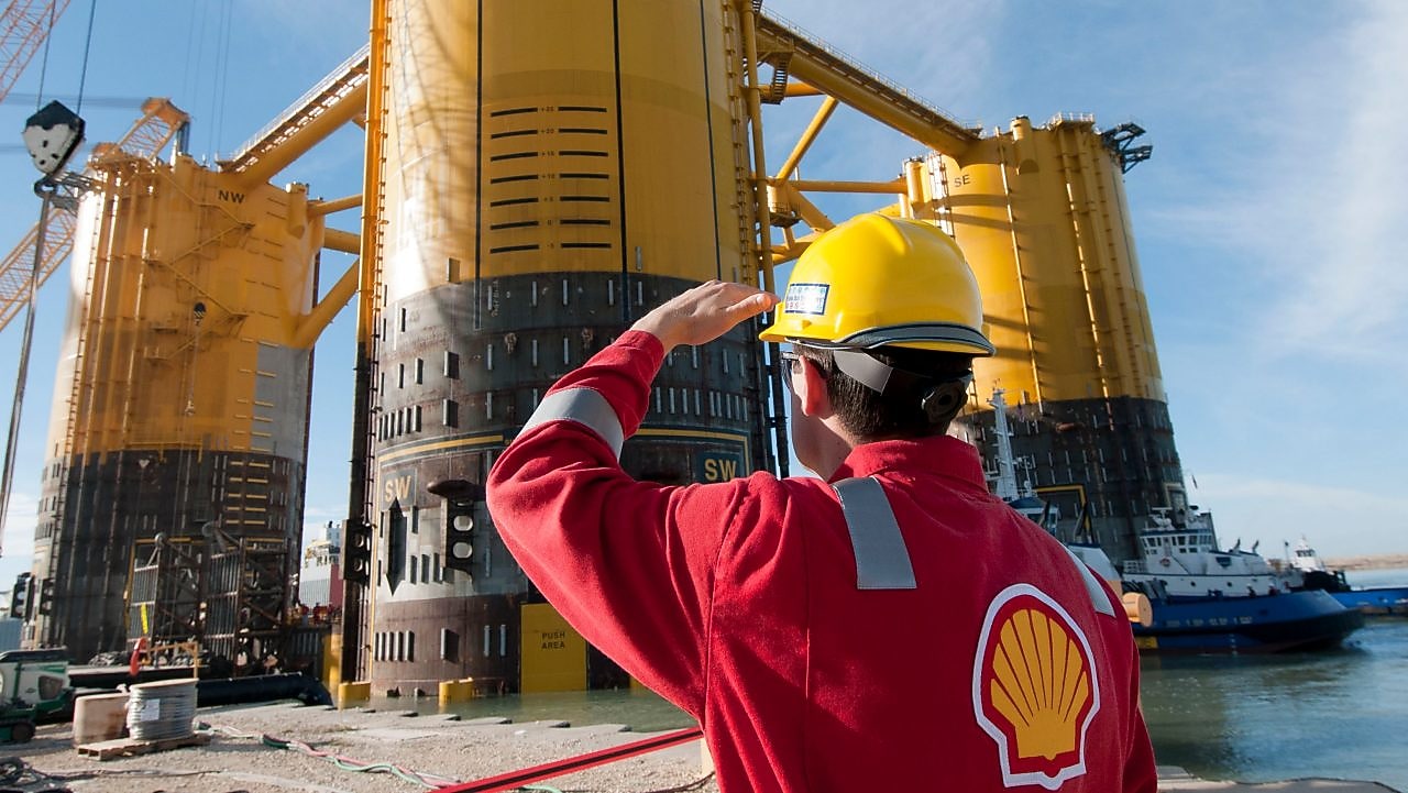 Engineer looking up at platform under construction