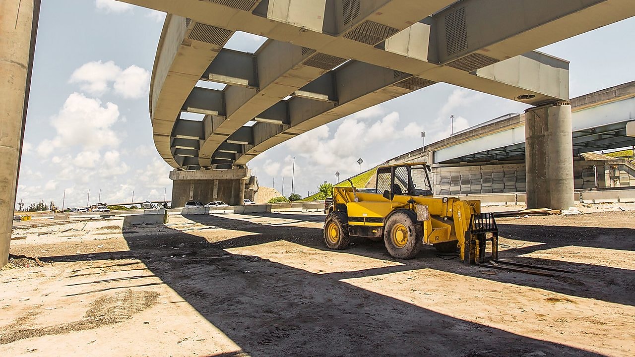 a digger truck under a flyover which is under construction