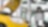 two cars in a garage, one yellow and one white, with their bonnets open, and some car tyres in the background