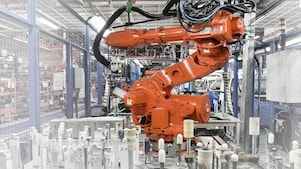 a red robotic arm in a factory