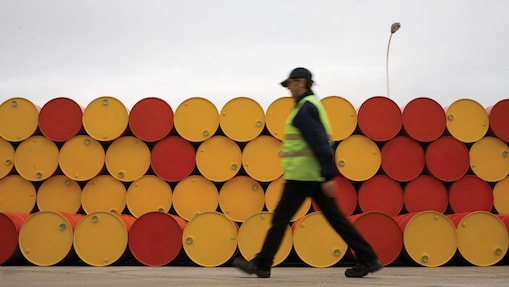 man walking barrels lubricants