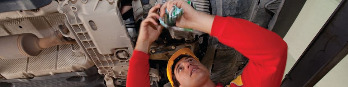 employee doing fitting of parts in car