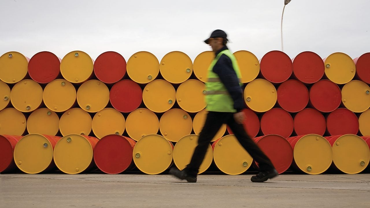 man walking barrels lubricants