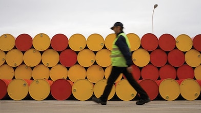 man walking barrels lubricants