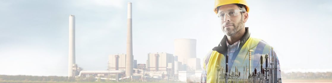 Worker in a yellow hard hat transposed onto a background of a power plant
