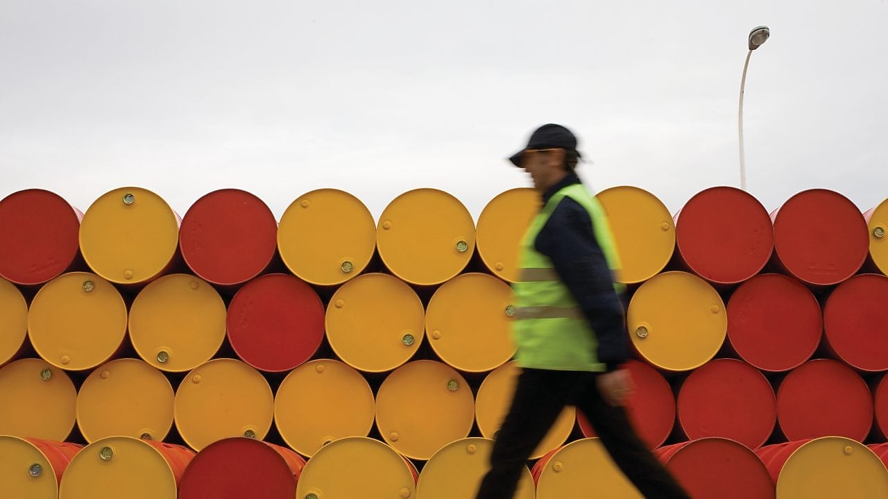 man walking barrels lubricants