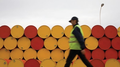 man walking barrels lubricants