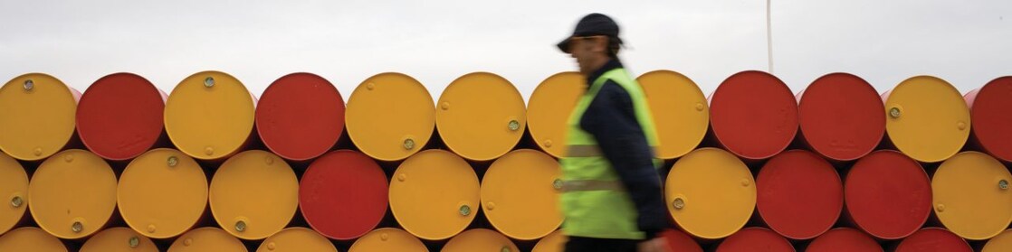 man walking barrels lubricants