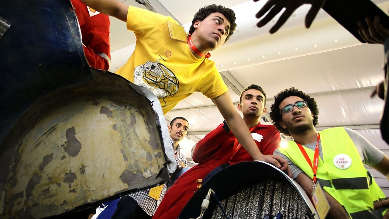 Team members huddle over the Anubis, #512, UrbanConcept, competing for team CUT Eco-Racing UC from Cairo University Faculty of Engineering , Egypt during day two of the Shell Eco-marathon in Manila, Philippines, Friday, Feb. 27, 2015.