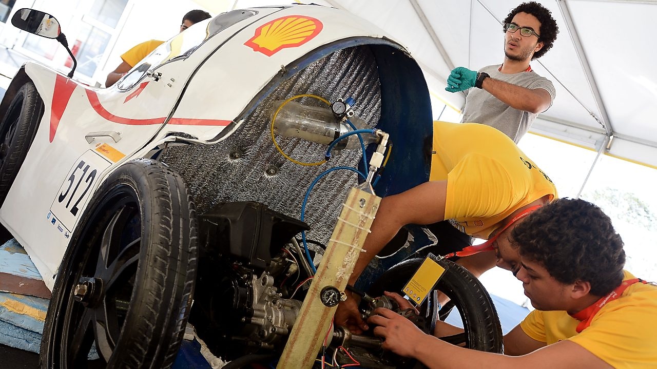 Team members work on the Anubis, #512, UrbanConcept, competing for team CUT Eco-Racing UC from Cairo University Faculty of Engineering , Egypt during day two of the Shell Eco-marathon in Manila, Philippines, Friday, Feb. 27, 2015.