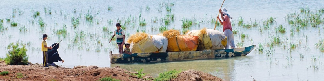 Local people cross the flooded Hawizeh Marshes, near the Majnoon project in Iraq