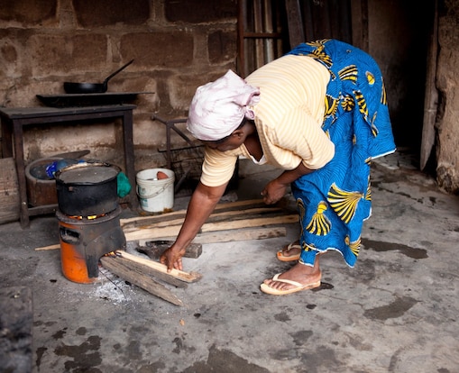 Lady cooking on a cookstove in Nigeria