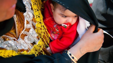 A parent holding their child