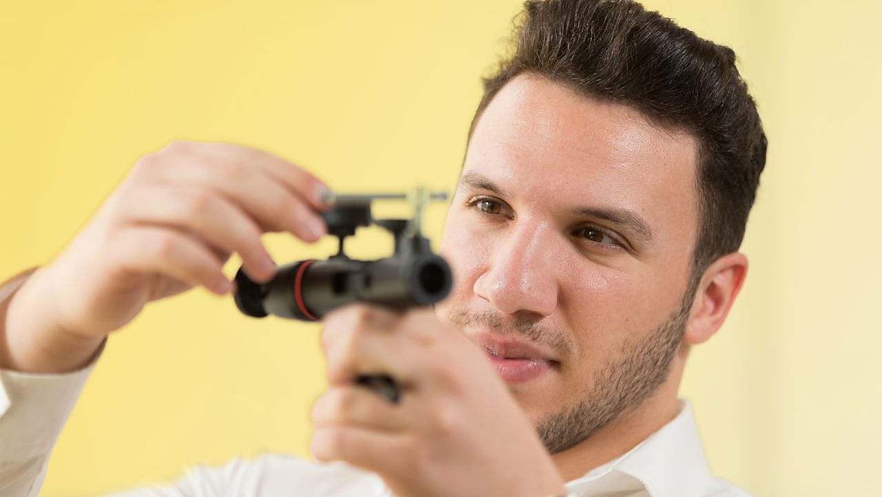 An employee stands in a field near a Quest C02 injection well northeast of Edmonton, Alberta in Canada